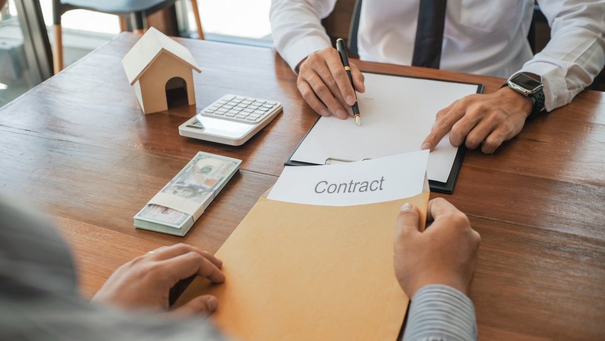 Business people negotiating for signÂ  contract. buy sell real estate contract Business concept and contract signing.